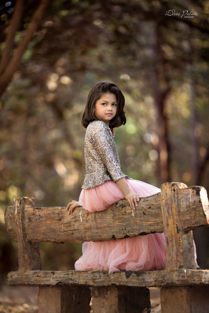 Beautiful girl sitting on bench in the forest